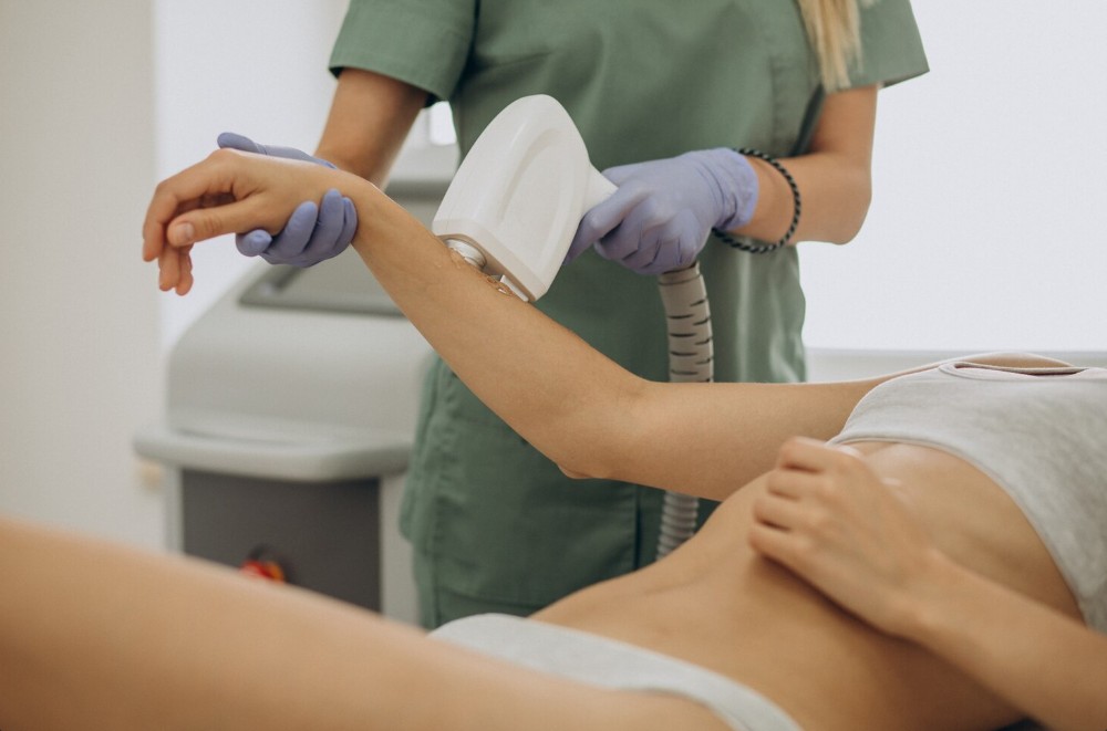 a lady lying down on bed having laser hair removal clinic in palmetto fl